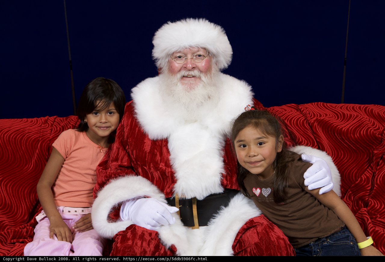 Santa Claus and Two Children on Red Couch