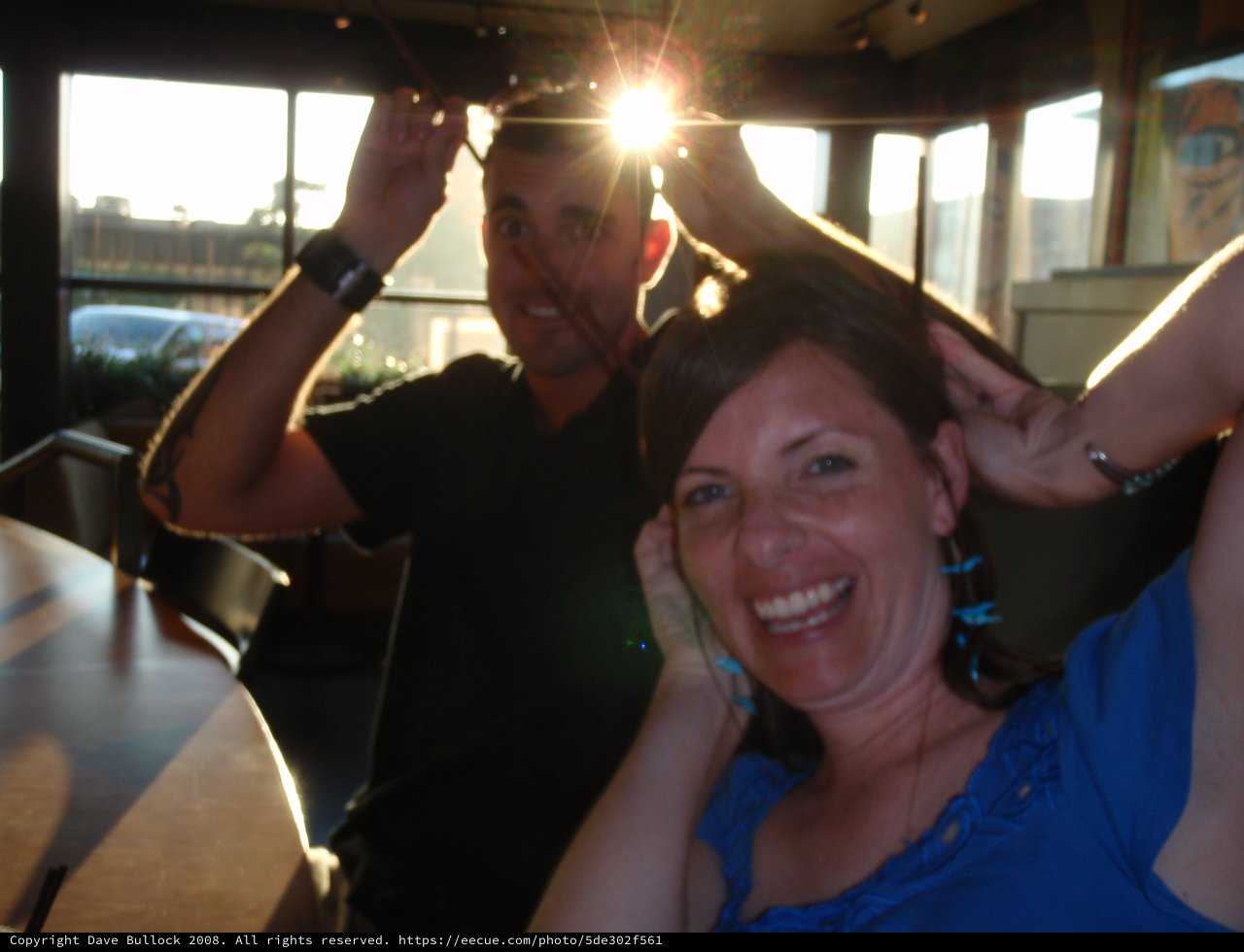 Friends Laughing Together at Sunset Restaurant