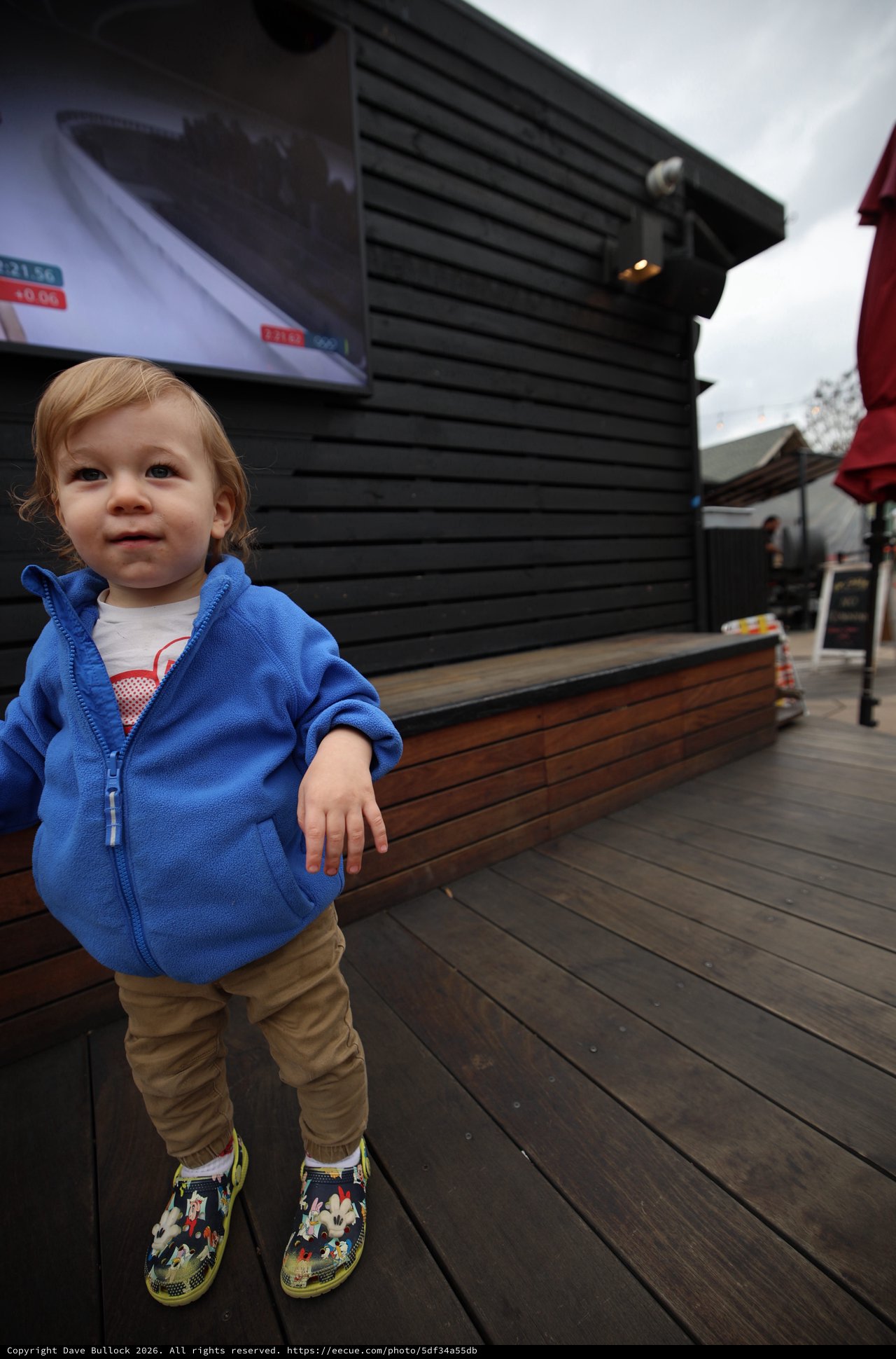 Toddler in Blue Hoodie at Outdoor Venue