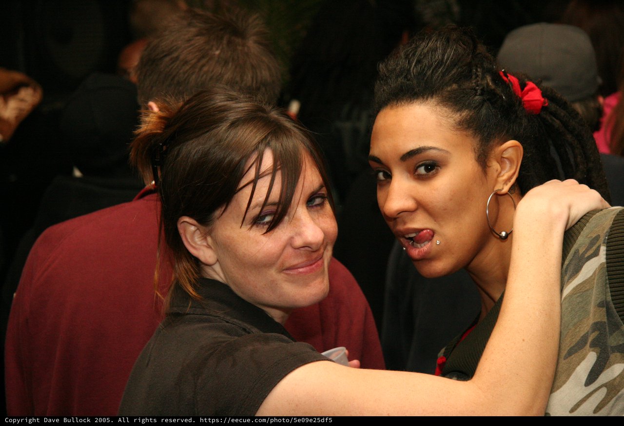 Two Friends Share a Playful Moment at a Party