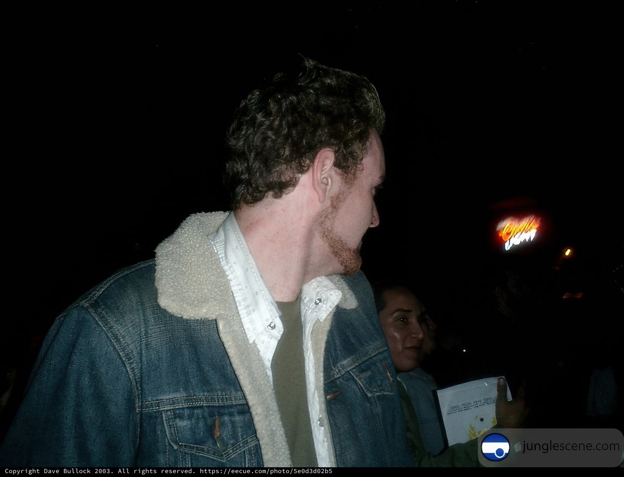 Man in Denim Jacket Addressing Crowd