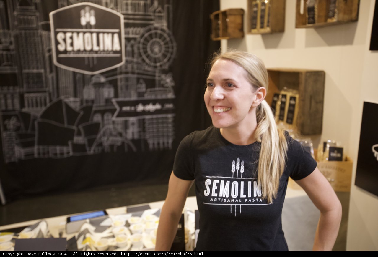 Blonde Teen in Black T-Shirt Poses in Front of Display