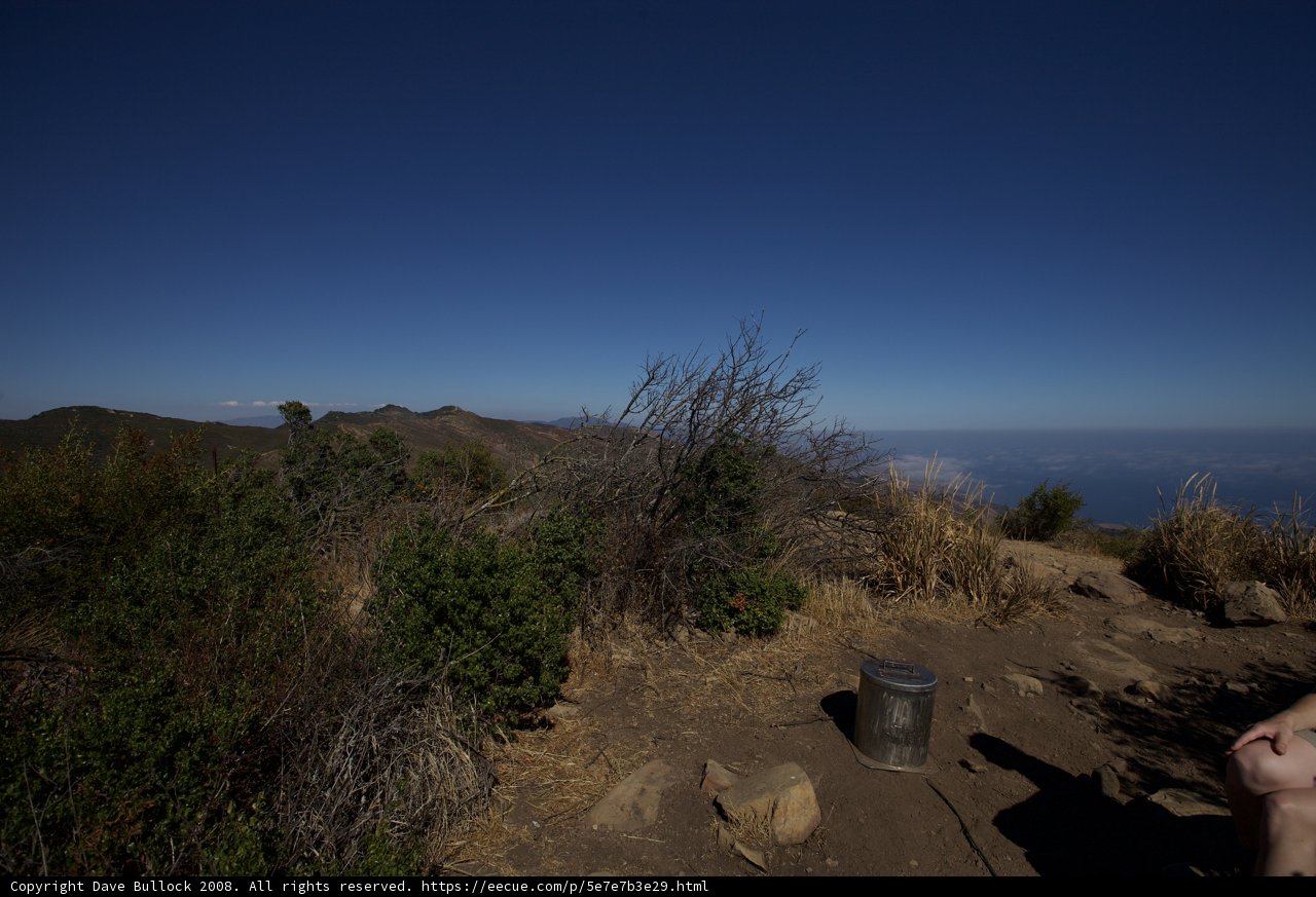 Man Relaxing with a Bucket on a Hill