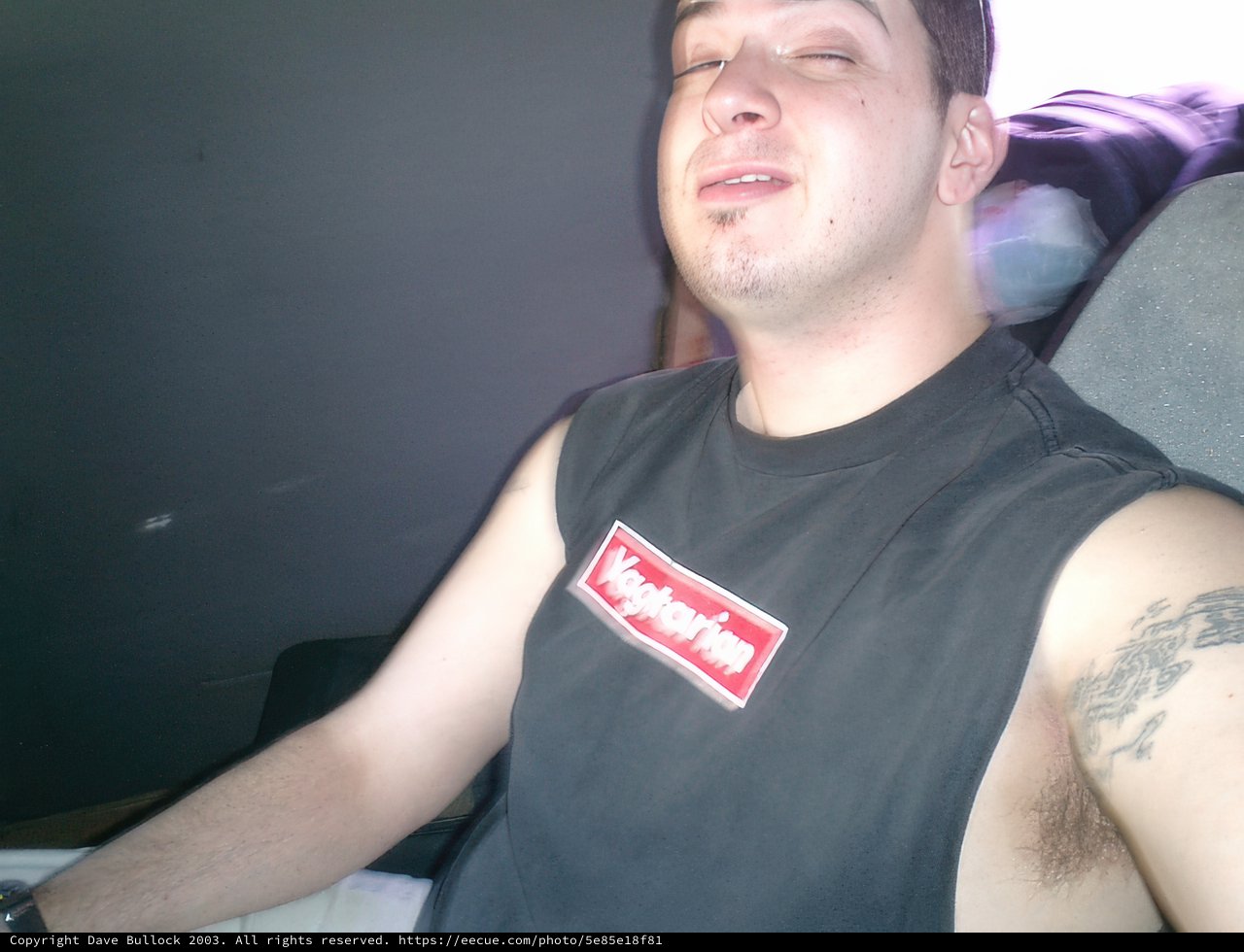 Tattooed Man Takes a Seat in his Car