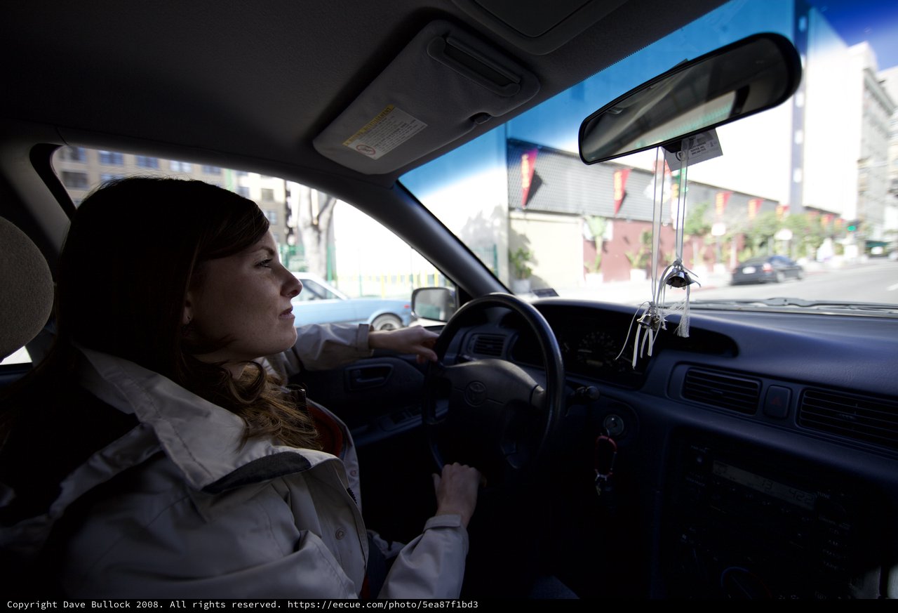 Woman Navigating Urban Streets in Winter Jacket