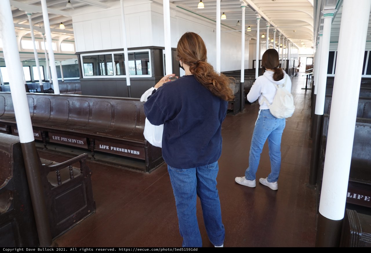 Visitors Exploring Historic Ship Interior Display