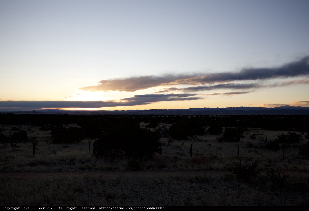 Desert Sunset Over Distant Mountains at Dusk