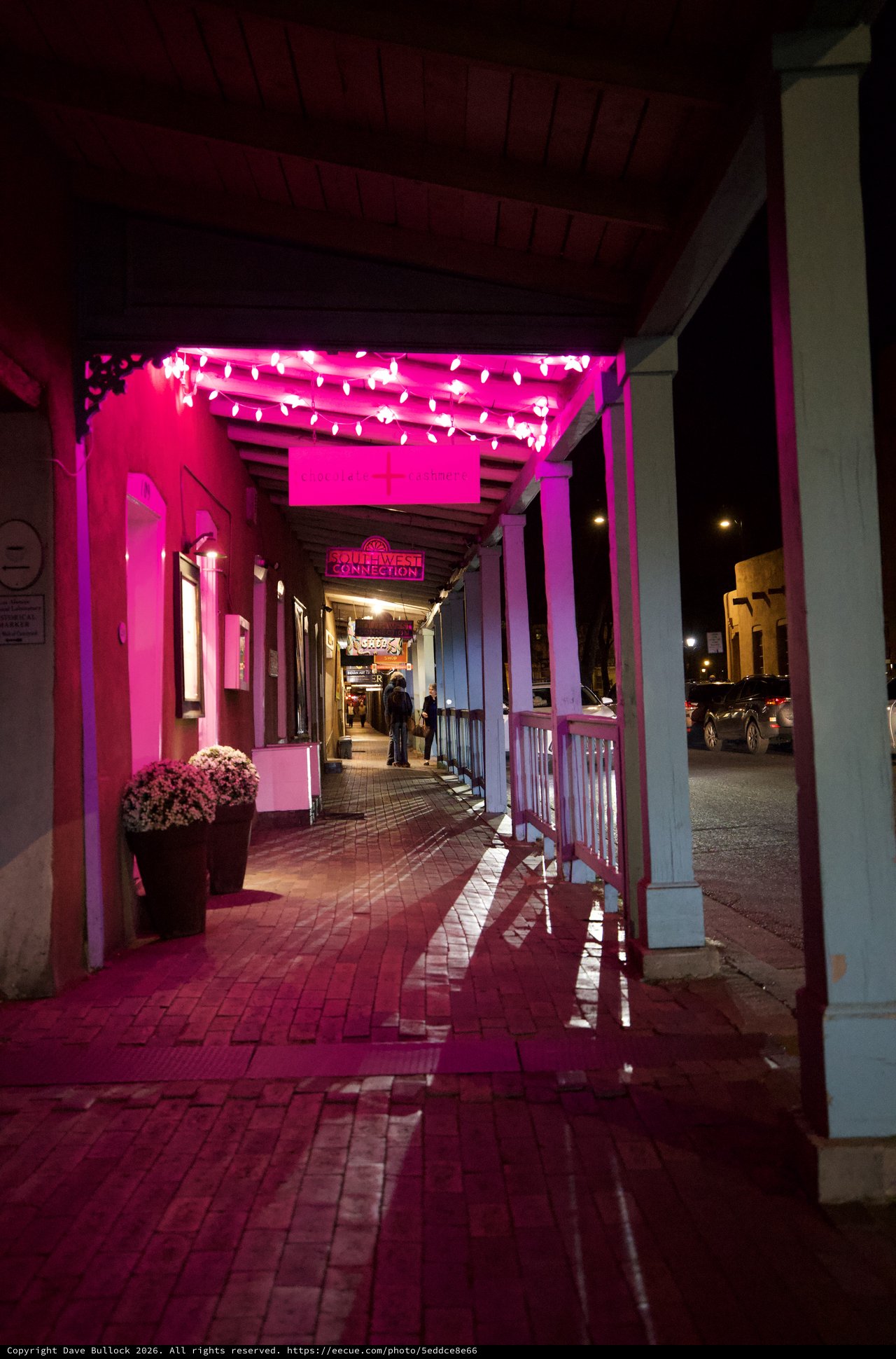 Pink-Lit Historic Storefront Corridor at Night