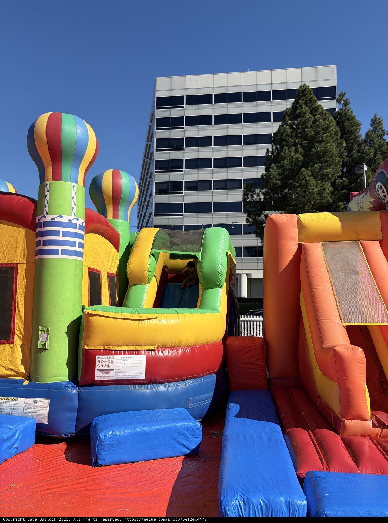 Colorful Inflatable Bounce House Complex at Urban Event