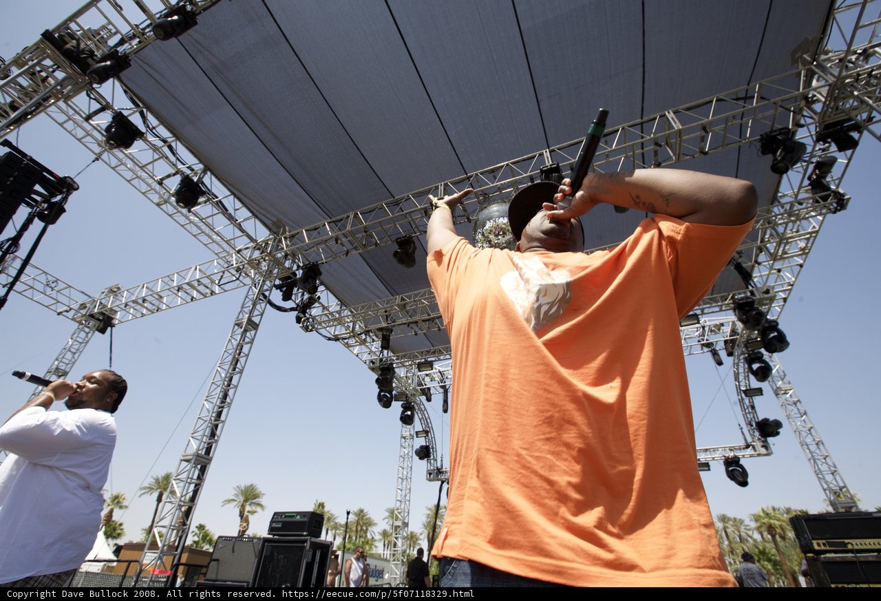 Man in Orange Shirt Takes the Stage at Coachella