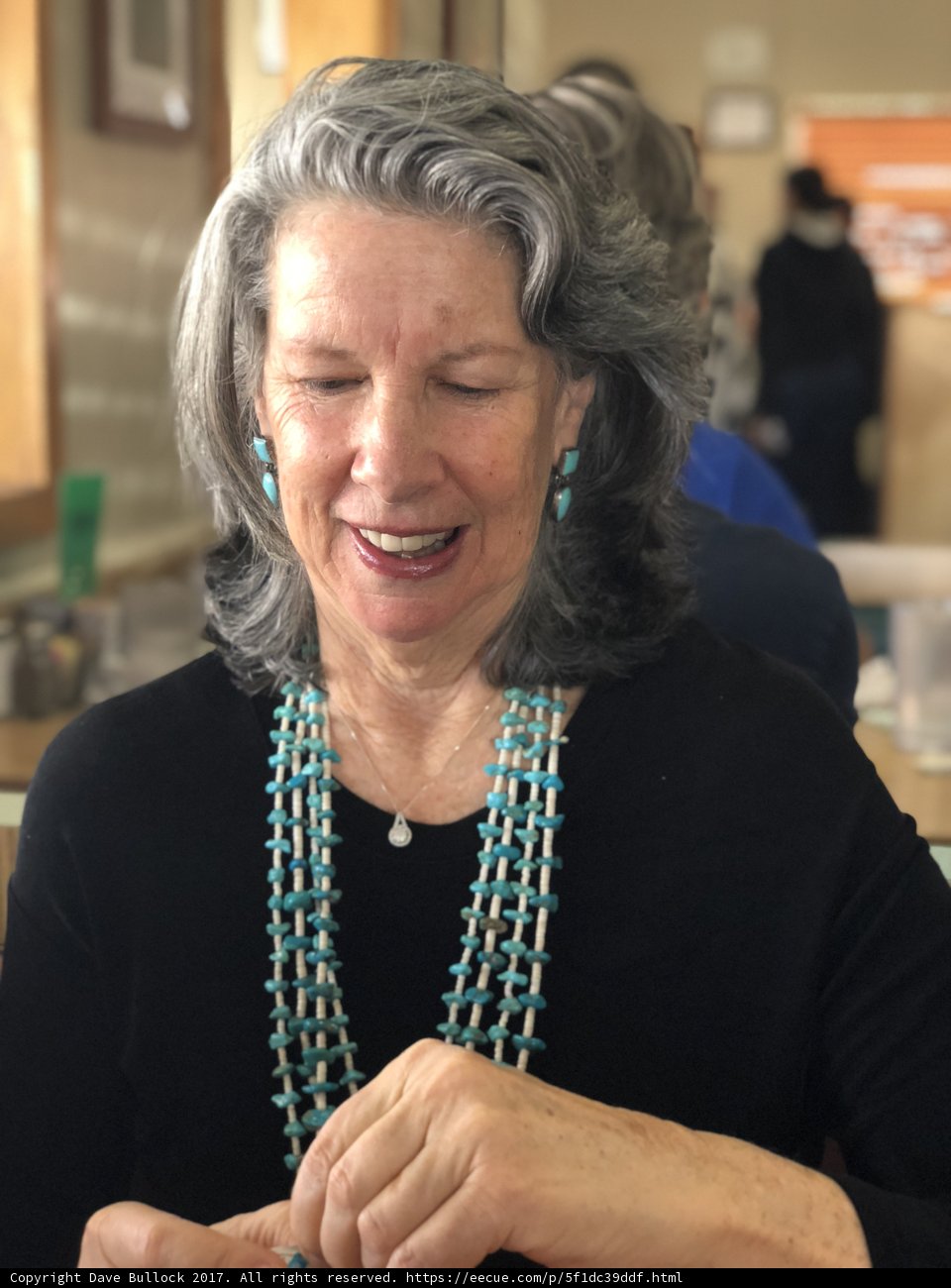 Gray-haired beauty wearing a stunning necklace