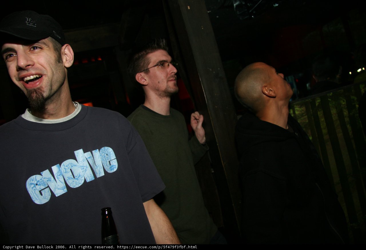 Three Men Enjoying a Night Out at a Bar