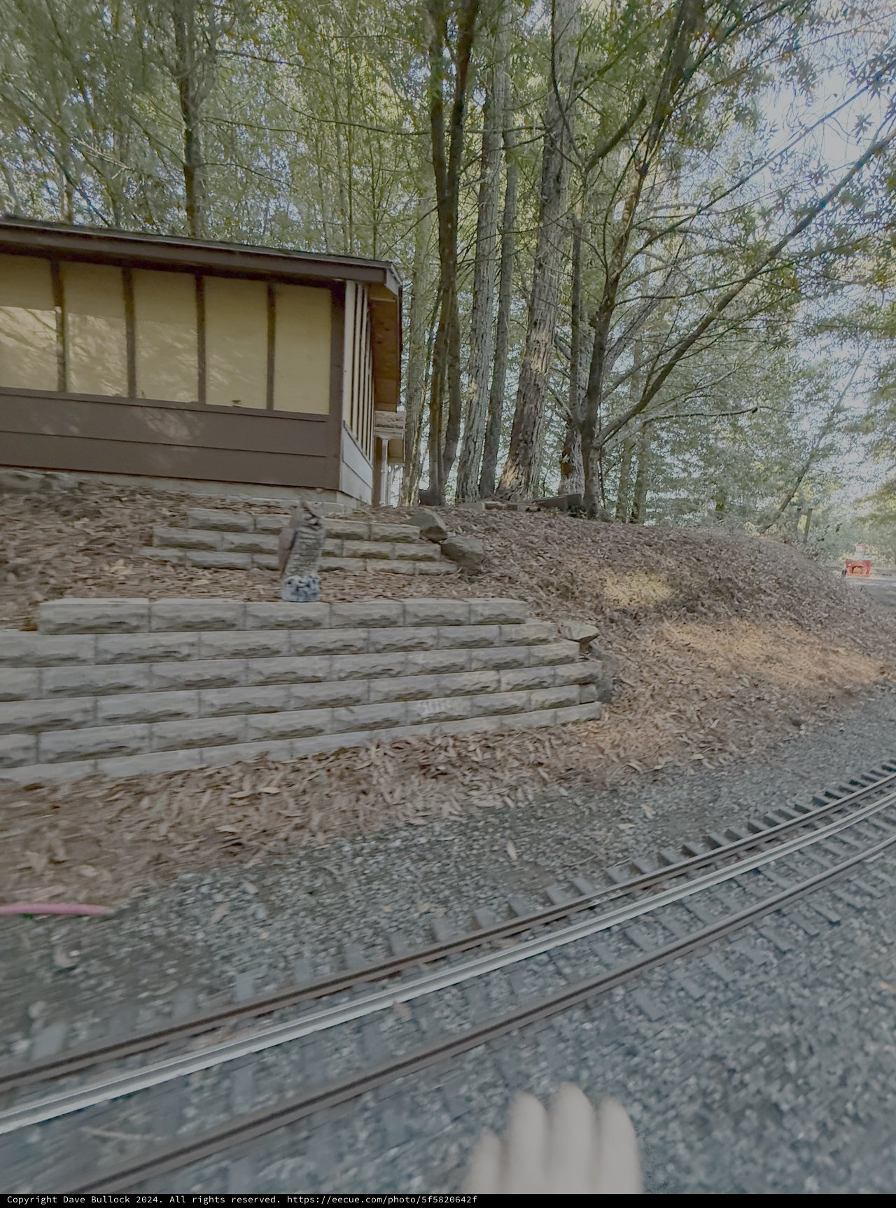 Modern House with Stone Retaining Wall and Railroad Tracks