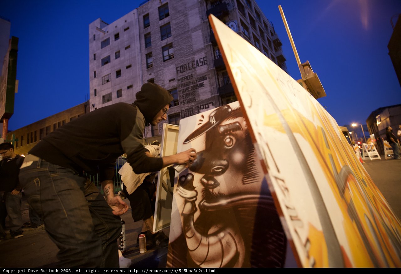 Urban Artist Creates Mural Amidst Blue Skies