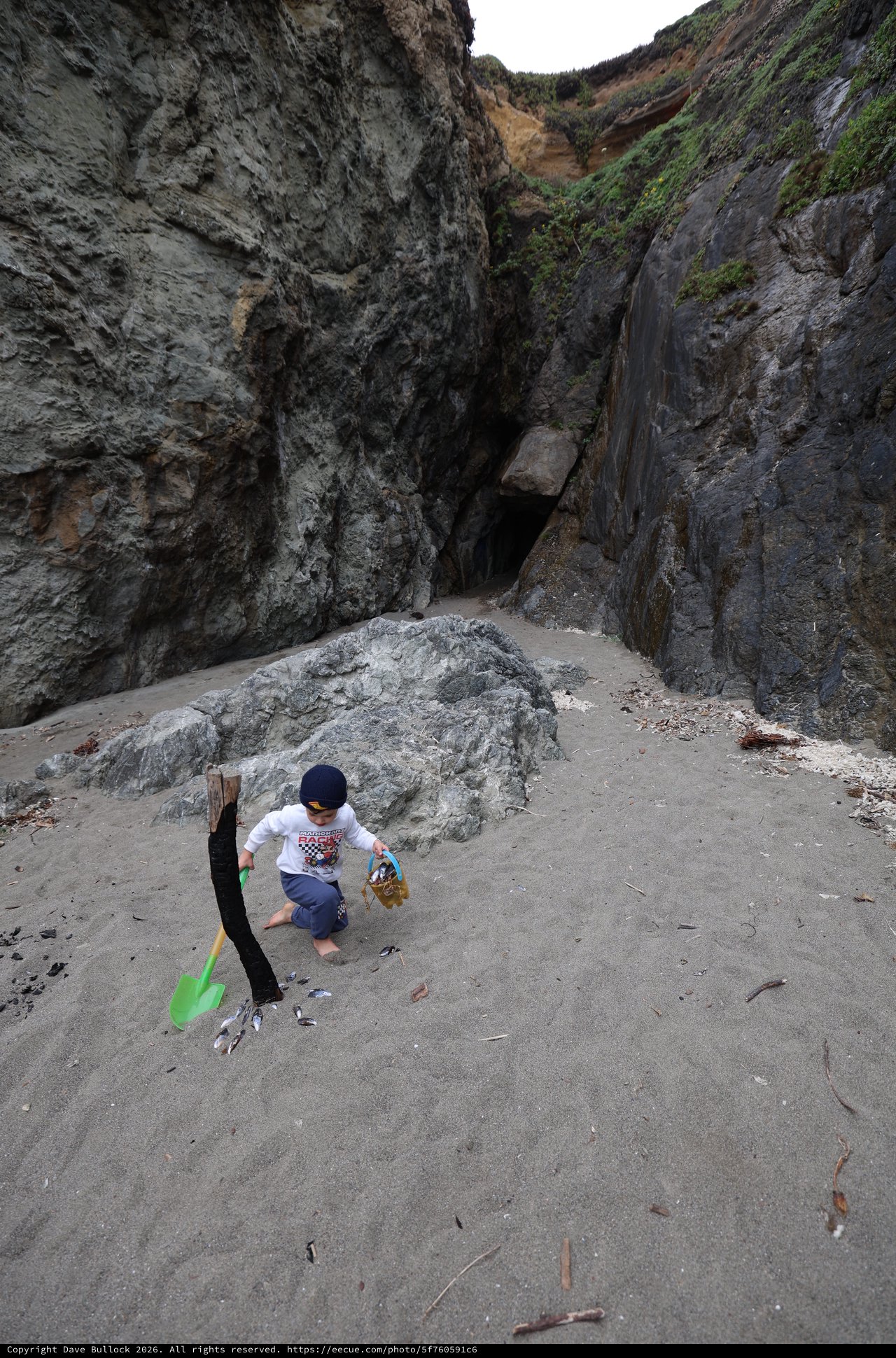 Young Explorer Discovers Sea Cave on Rugged Beach