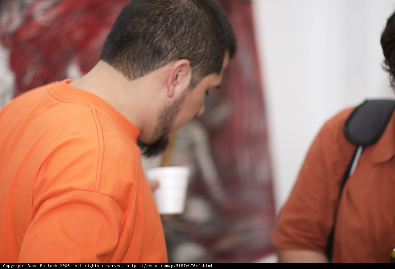 Orange Shirted Man at Table
