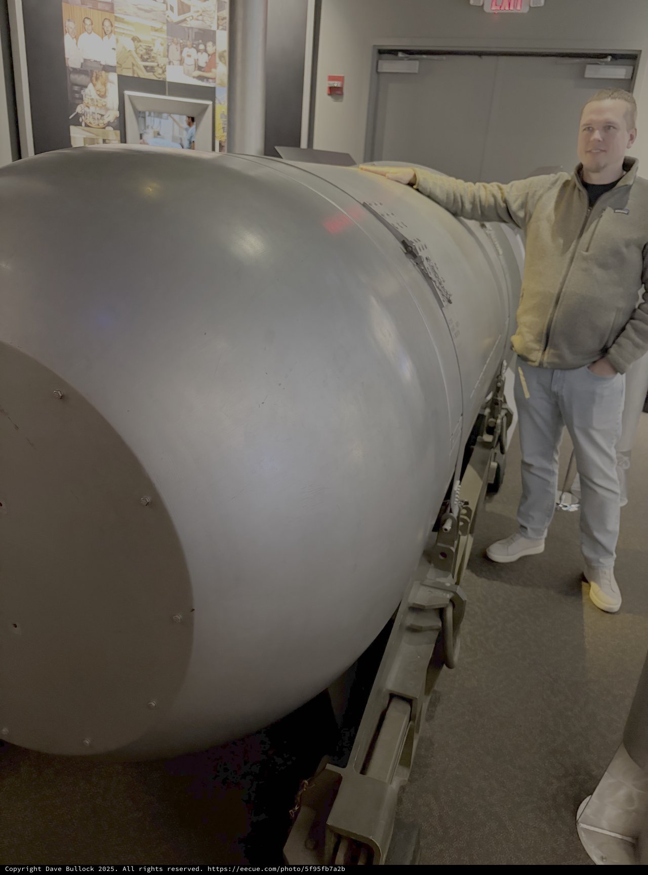 Man Posing with Large Cylindrical Military Equipment
