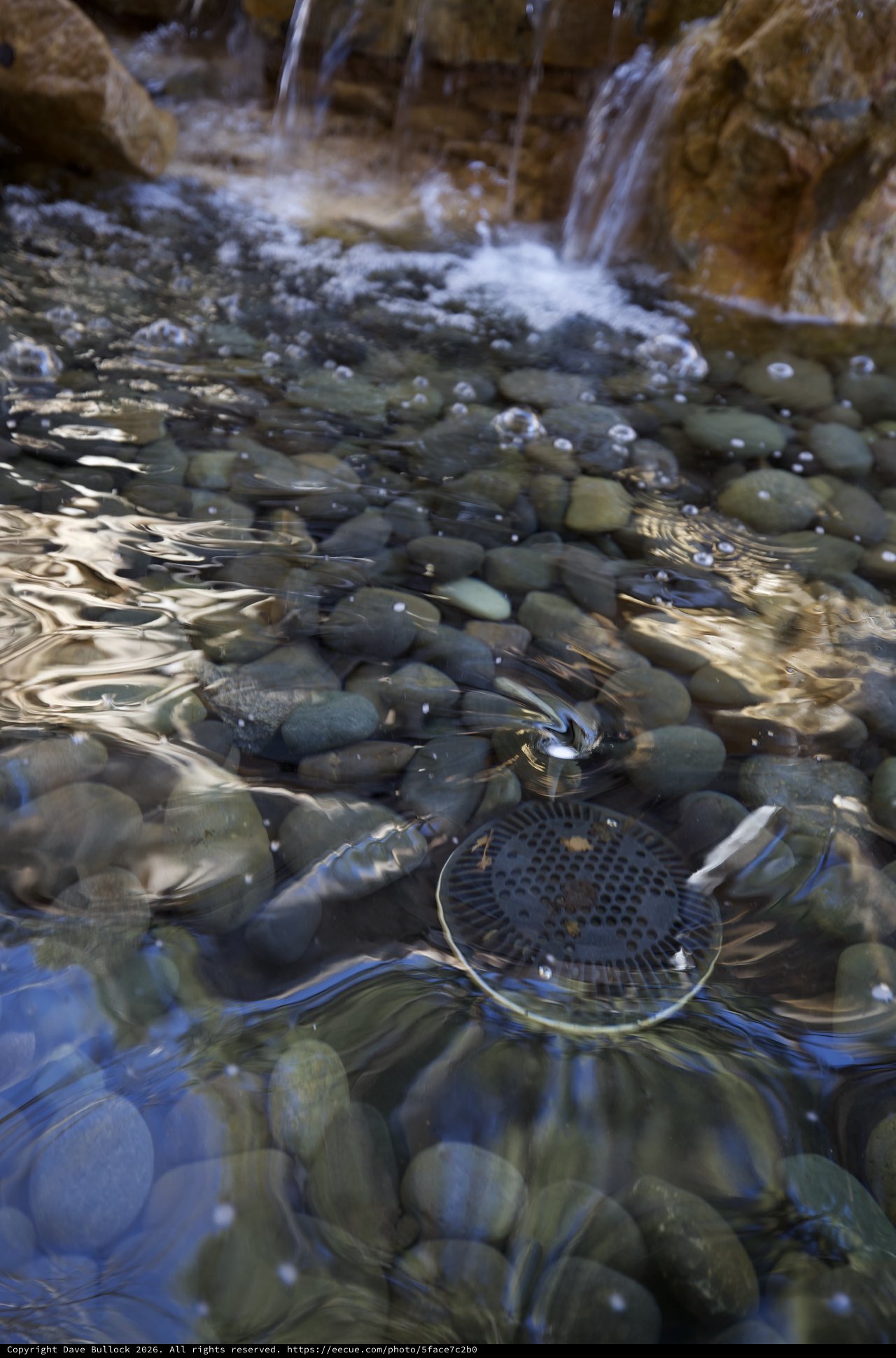Rippling Stream Over Smooth River Stones