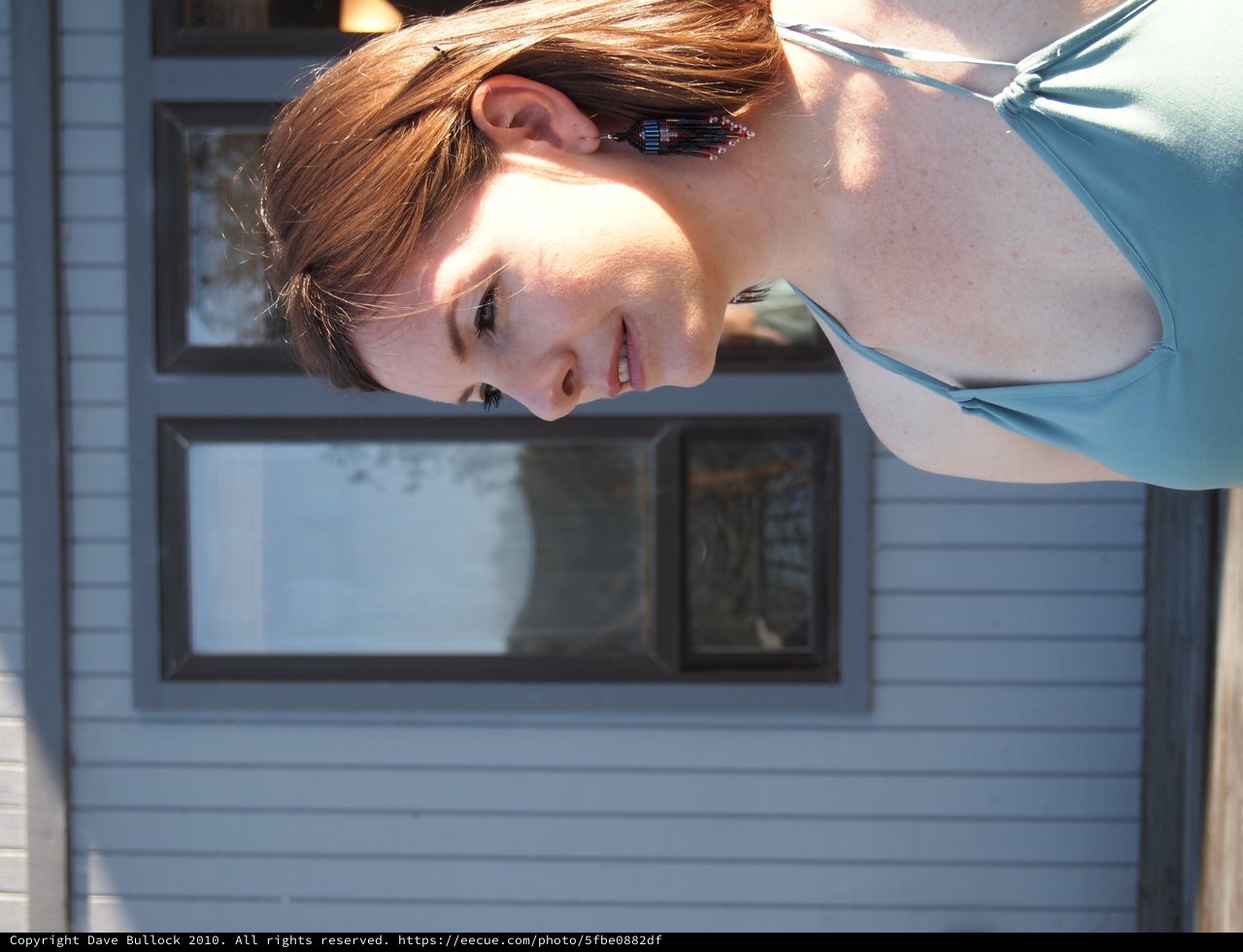 Sunlit Portrait of Redhead Woman in Teal Dress