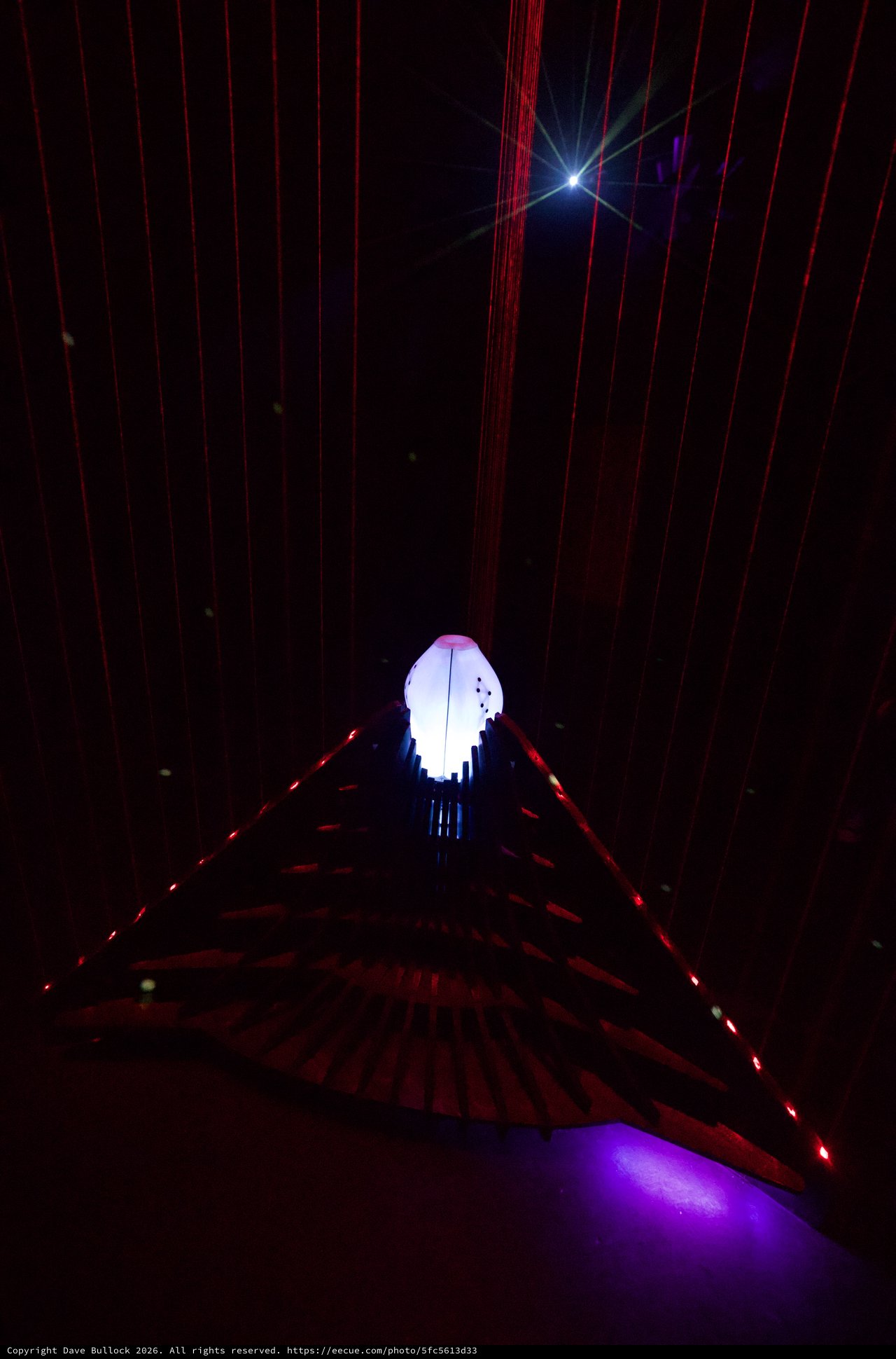 Illuminated Art Installation with Red Laser Beams
