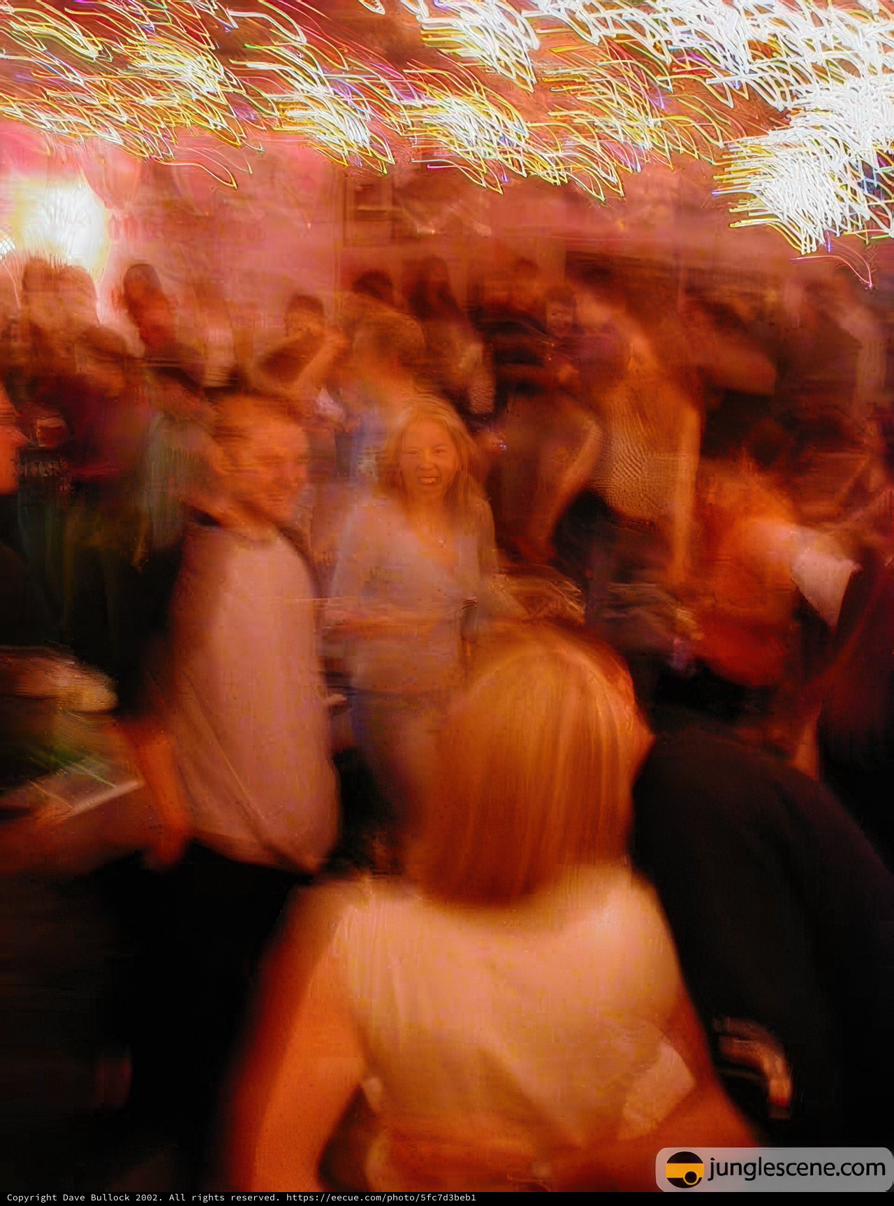 Nightclub Celebration Caption: A energetic party at a vibrant nightclub, filled with a lively crowd of people dancing with joy and celebratory energy.