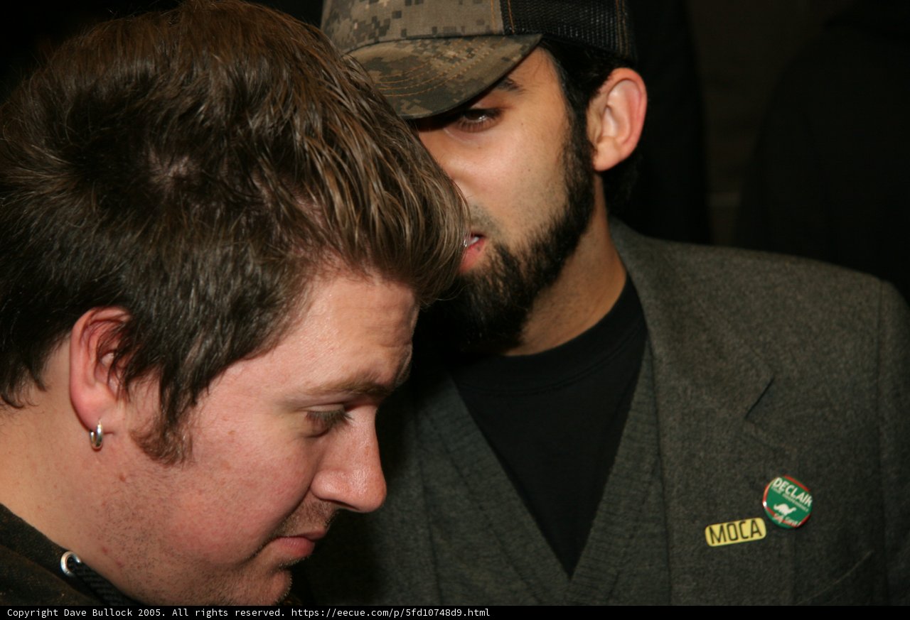 The Bearded Gentlemen Caption: Two men rock their hats and formal wear with some extra scruff on the face.