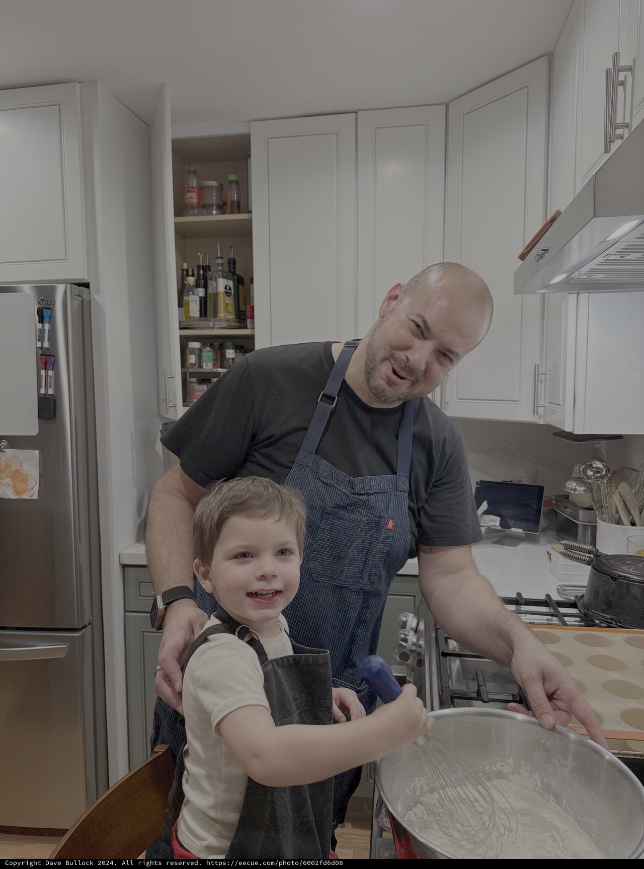 Father and Son Cooking Together in Modern Kitchen