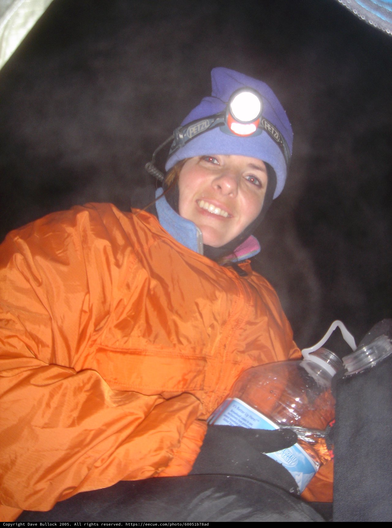 Smiling Climber Resting in Tent at Night