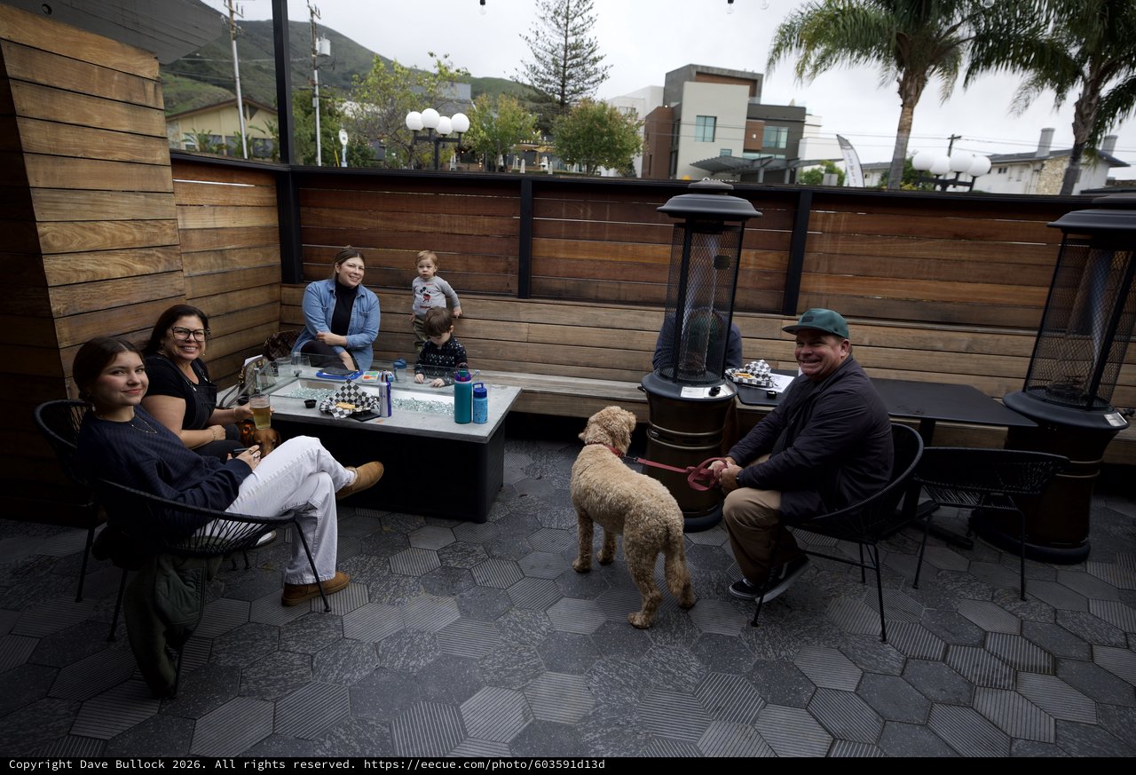 Family Gathering Around Patio Fire Pit at Dusk