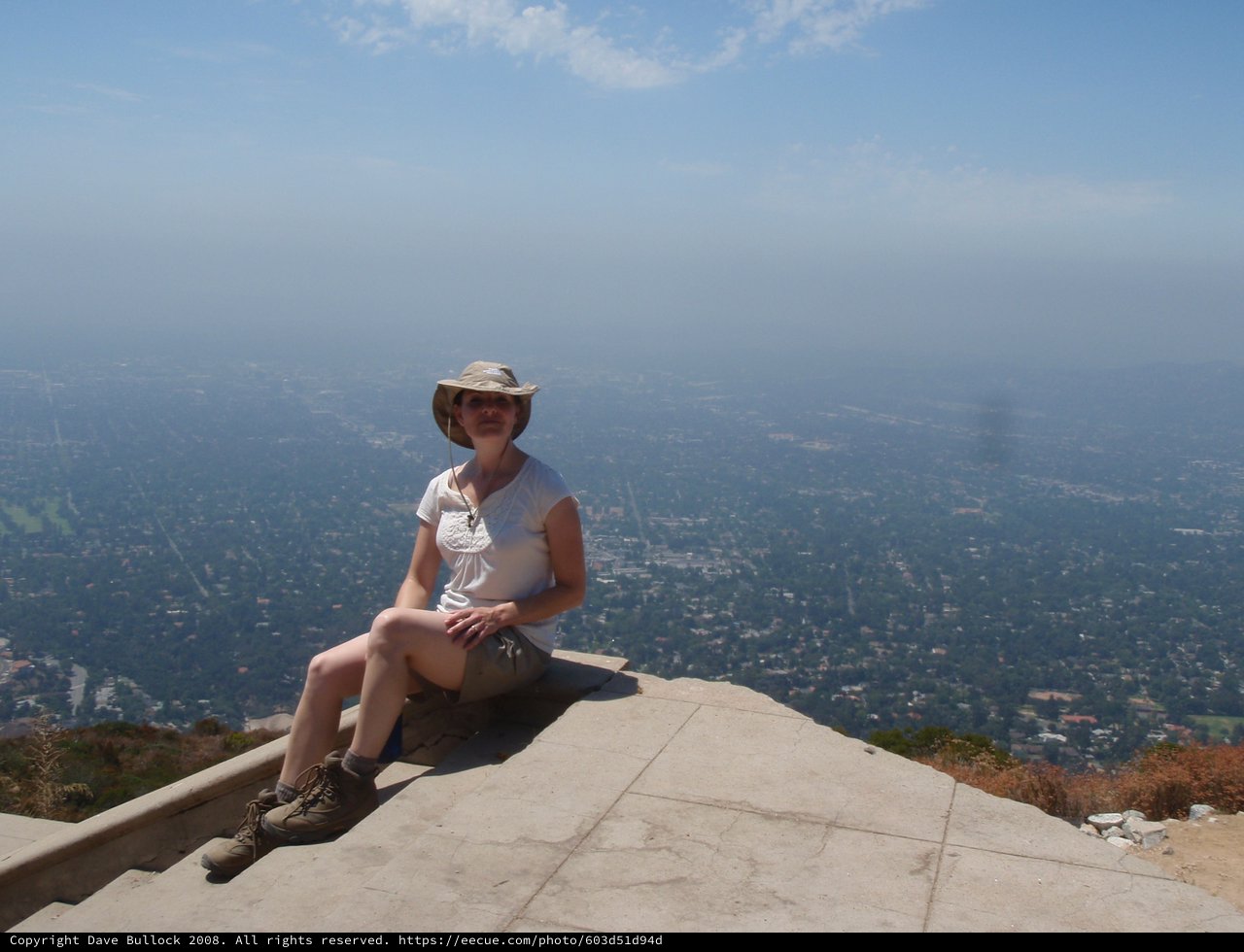 Hiker Rests at Summit Overlooking Smoggy LA Basin