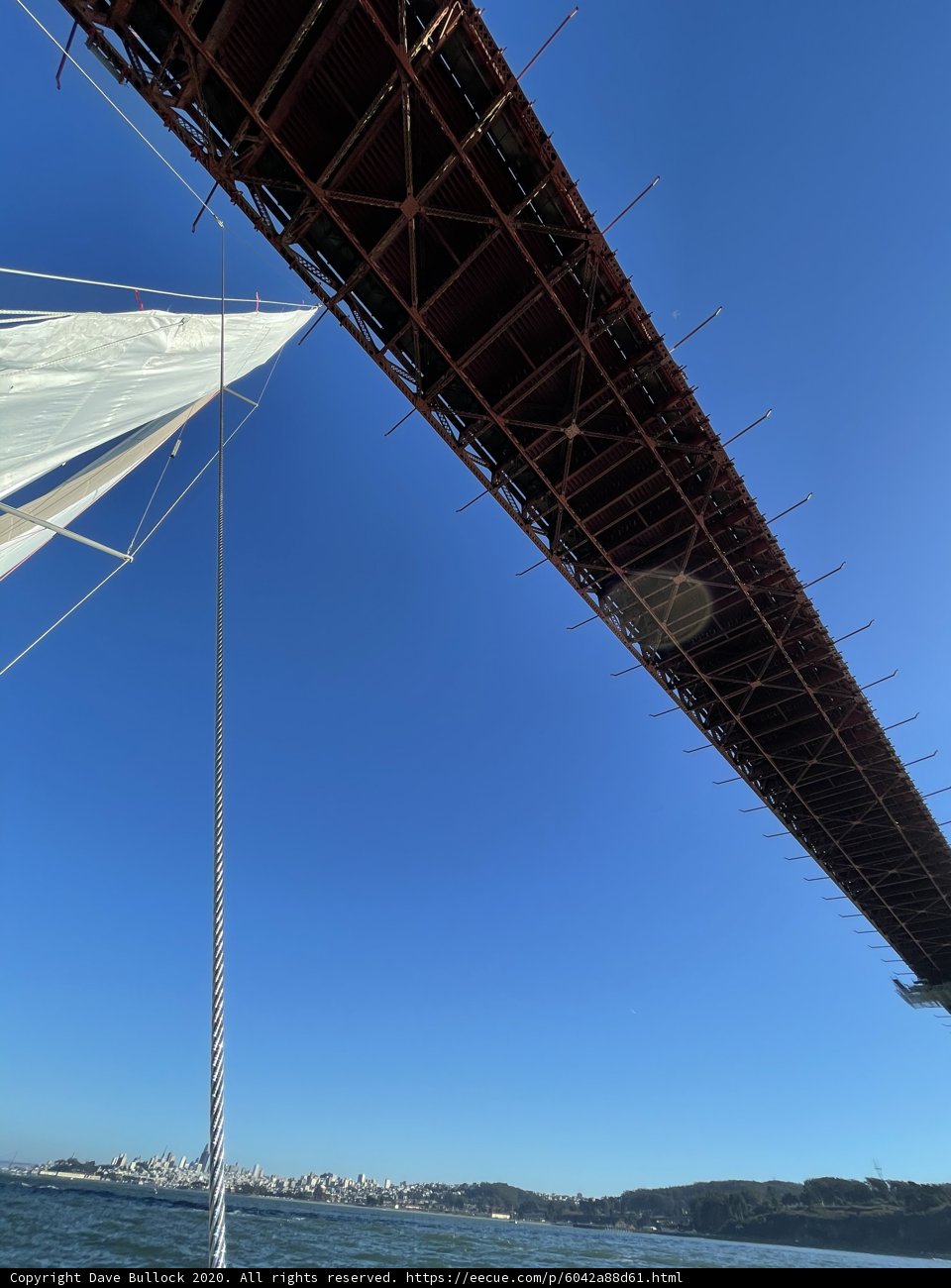 Golden Gate Bridge shining under brilliant blue sky