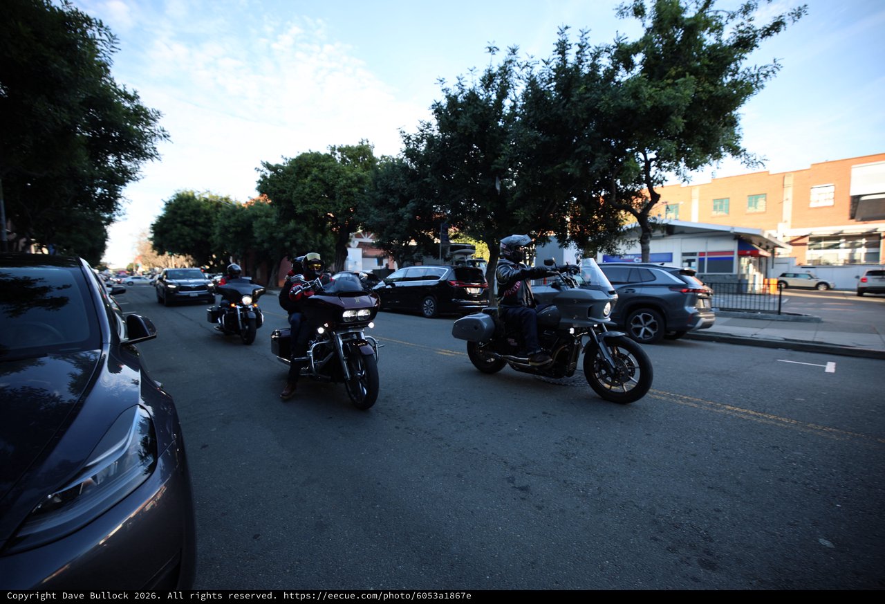 Motorcyclists Cruising Through Evening Urban Street