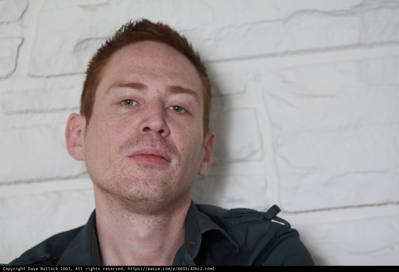 Red-headed man in black shirt