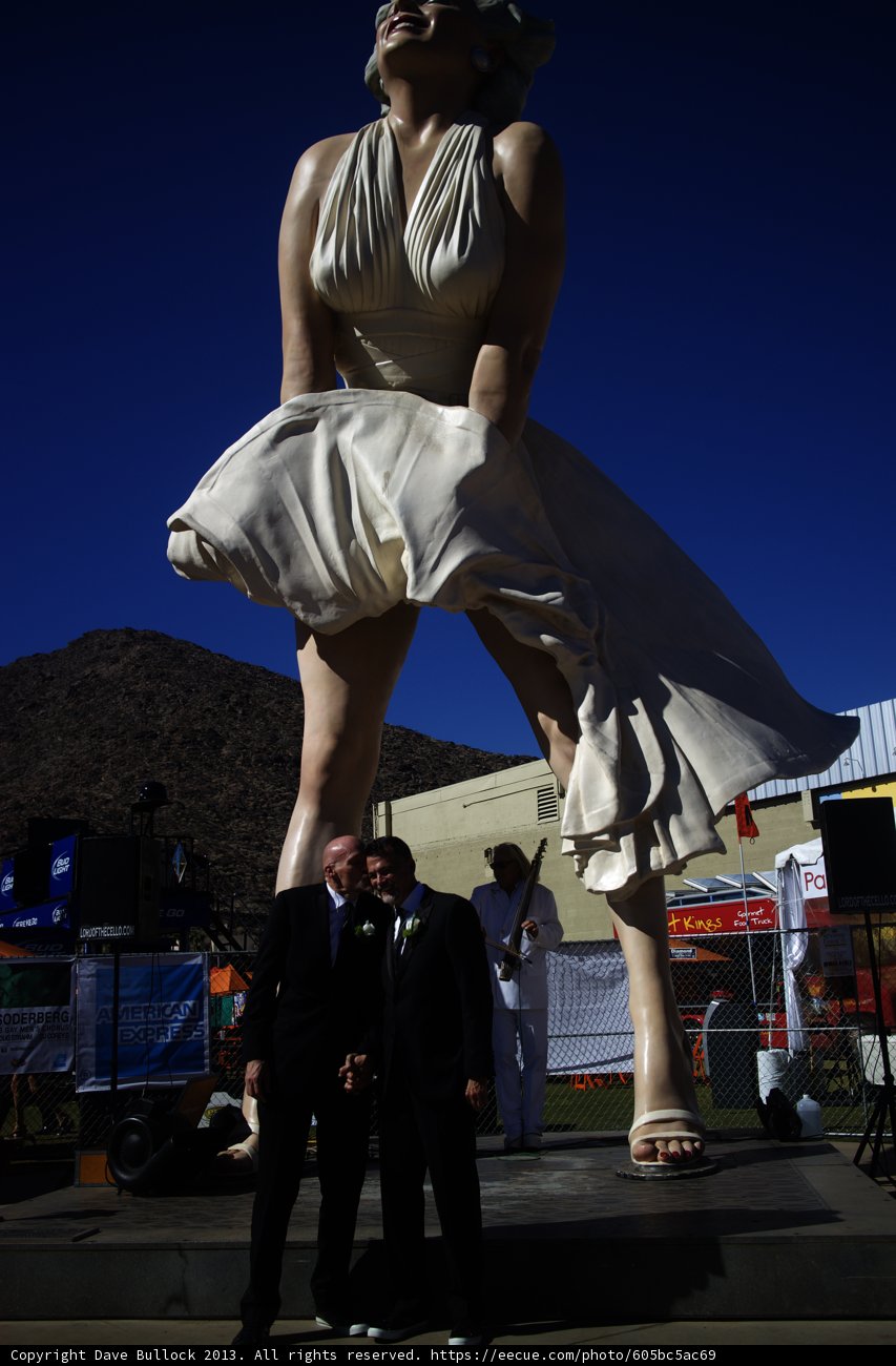 Clive Palmer posing with statue of woman in dress