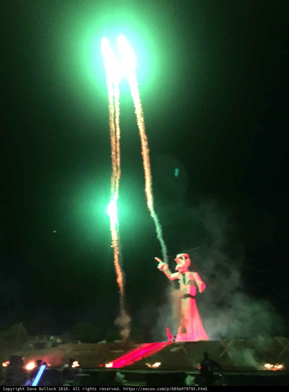Statue of Man with Lighted Torch in Night Sky