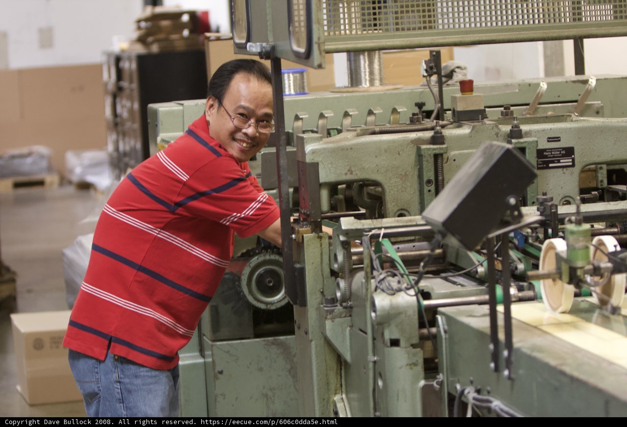 Happy Worker in a Busy Factory