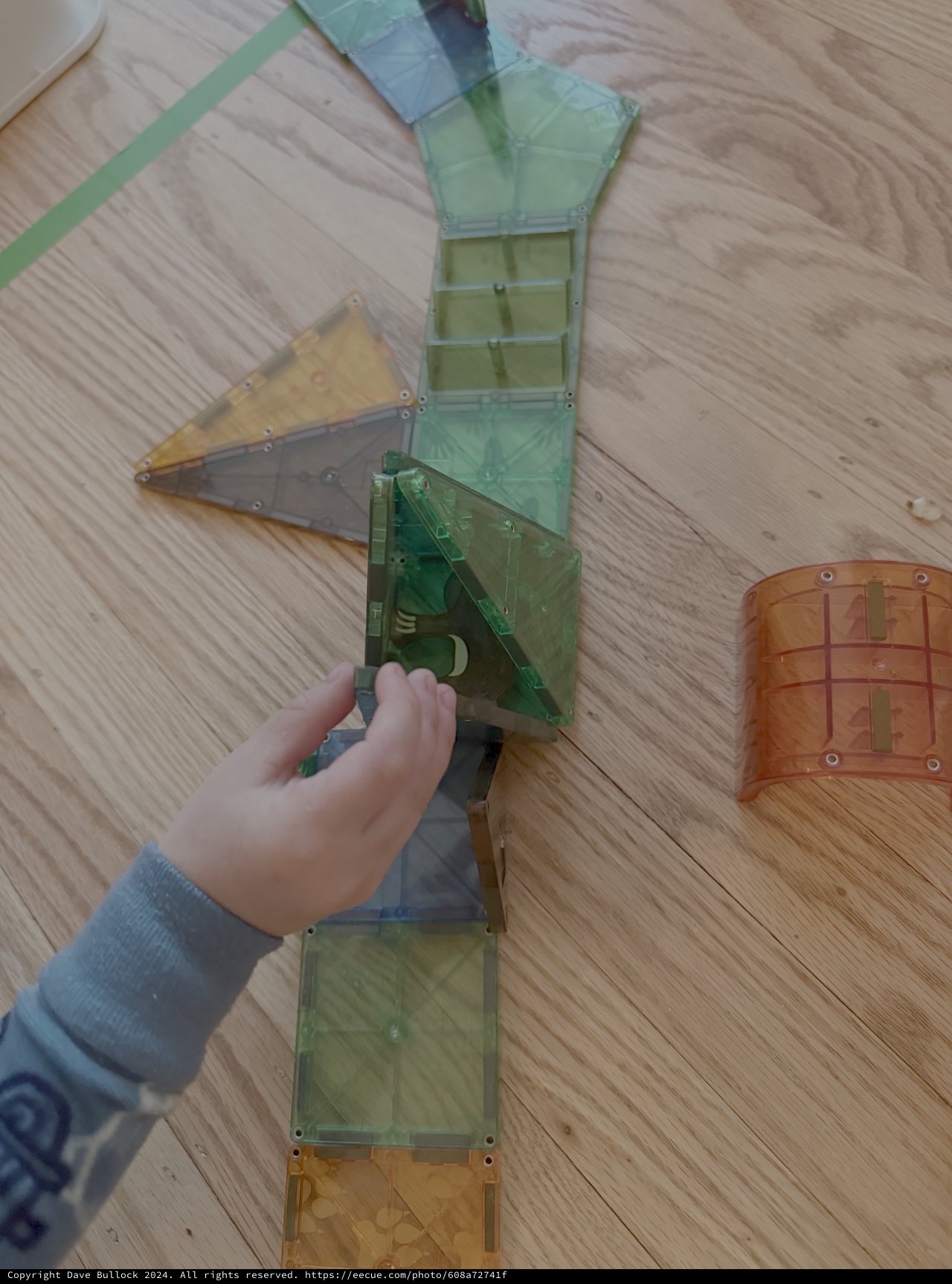 Child Playing with Colorful Magnetic Building Tiles