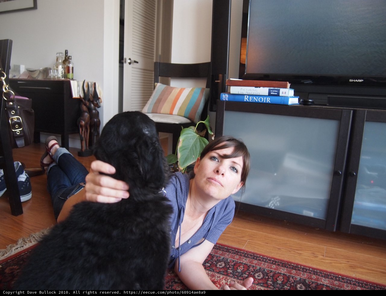 Woman and Black Dog Share a Quiet Moment