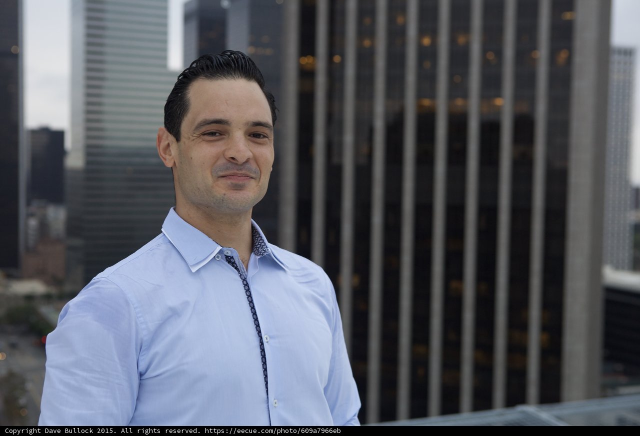 Blue-Shirted Man in Front of City Skyline