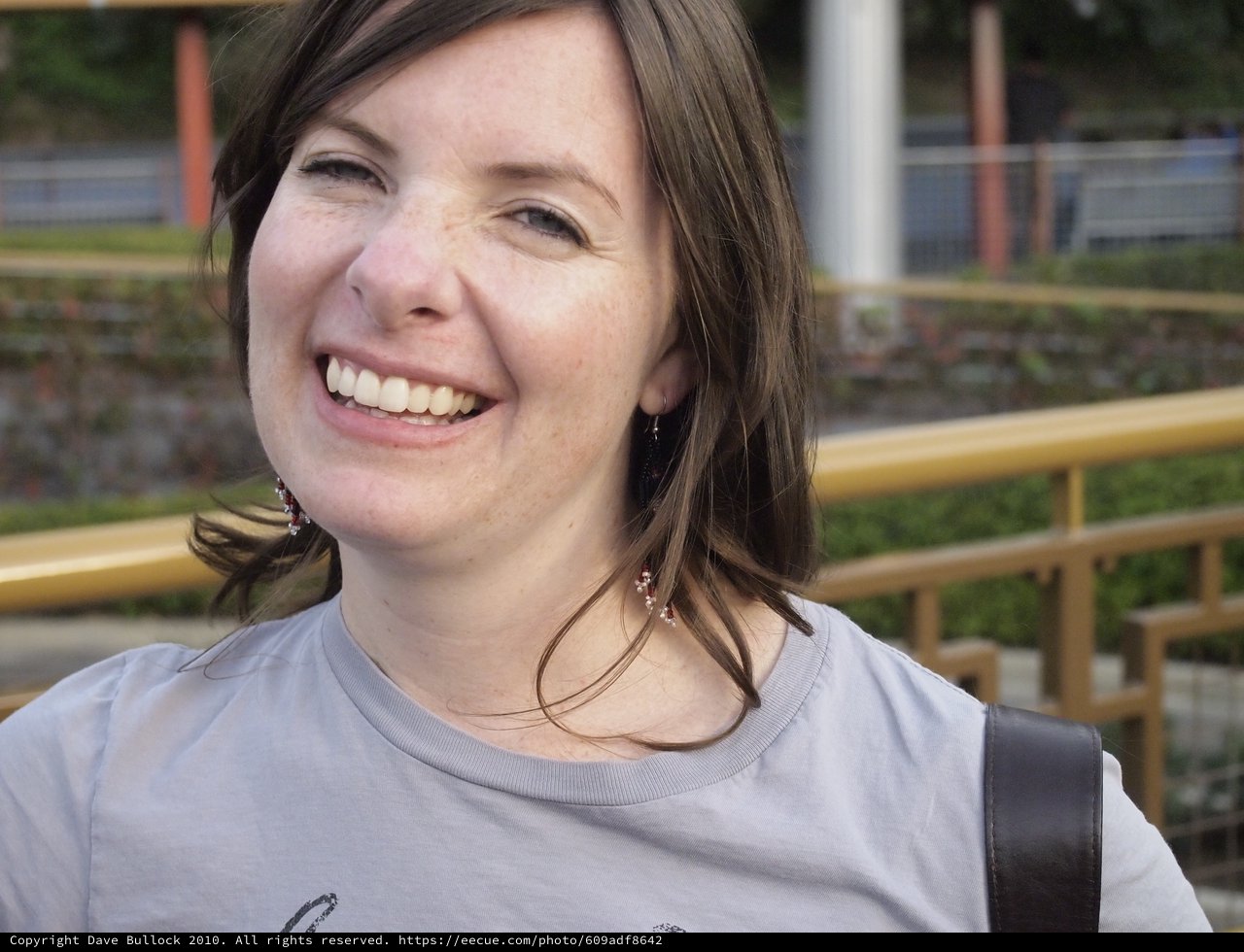 Joyful Woman Laughing Outdoors at Urban Park