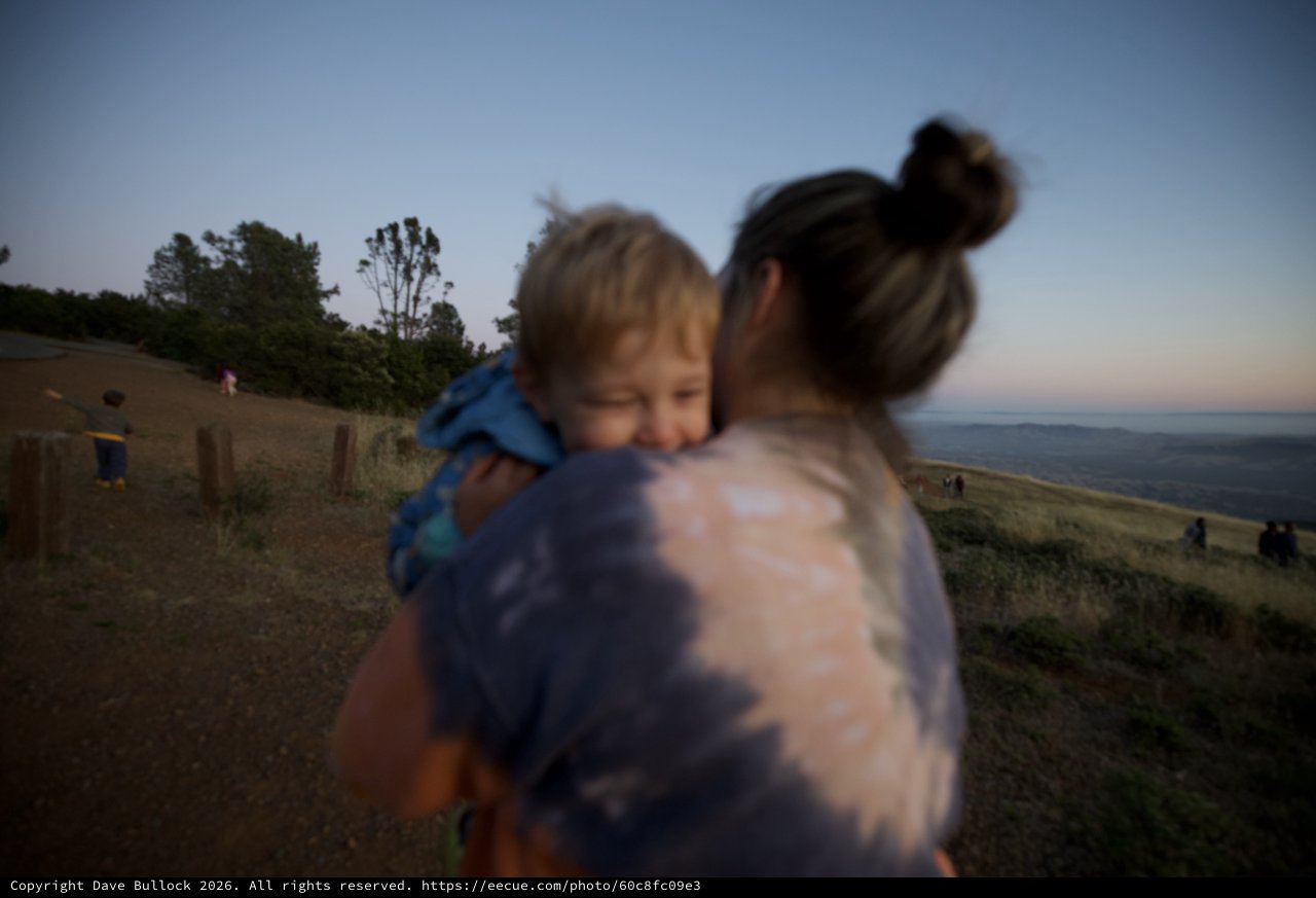 Mother and Child Embrace at Twilight Hilltop