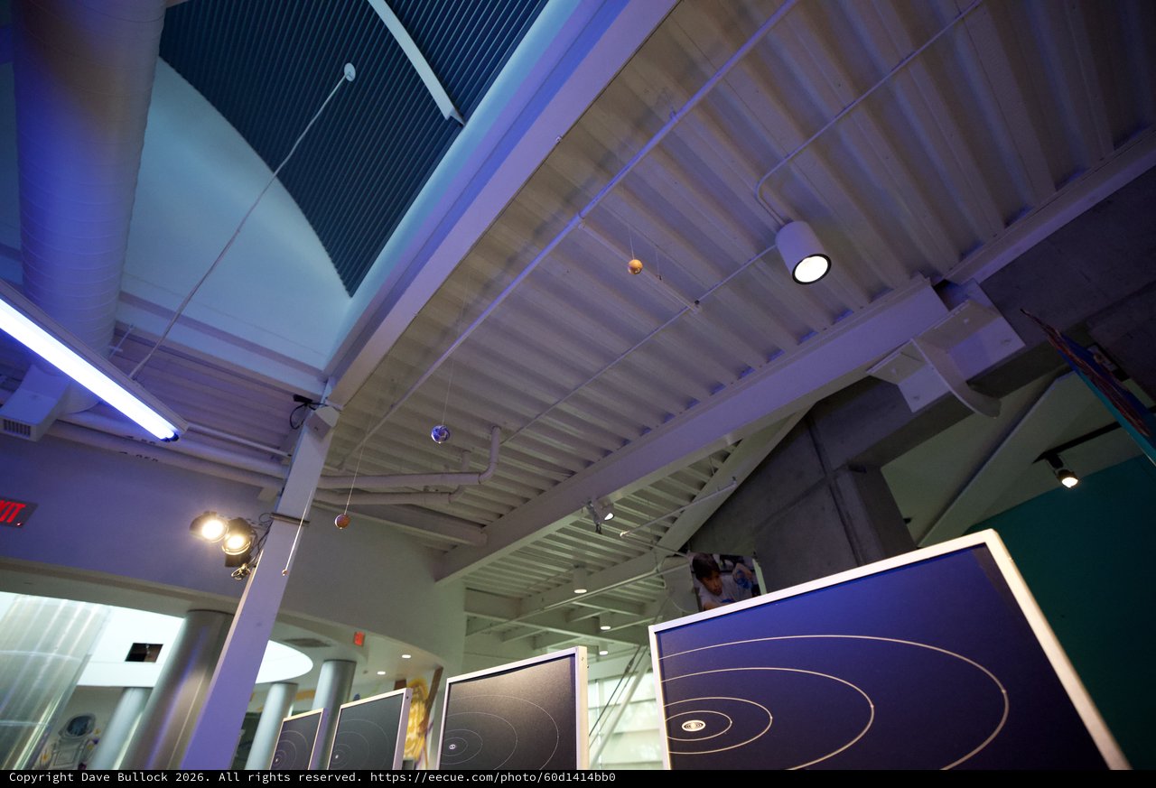 Modern Science Museum Interior with Orbital Display Panels