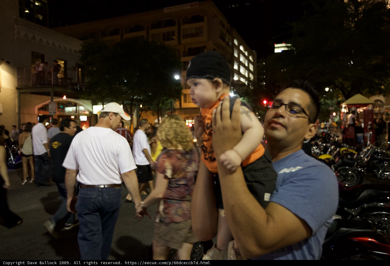 Nighttime Crowd with Father and Child