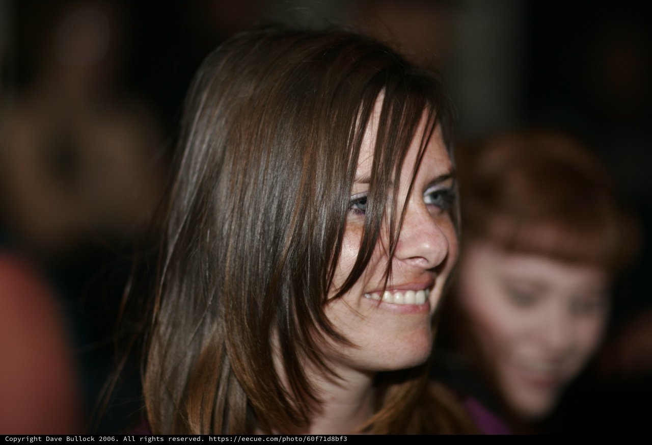 Candid Smile of a Young Woman in Crowd