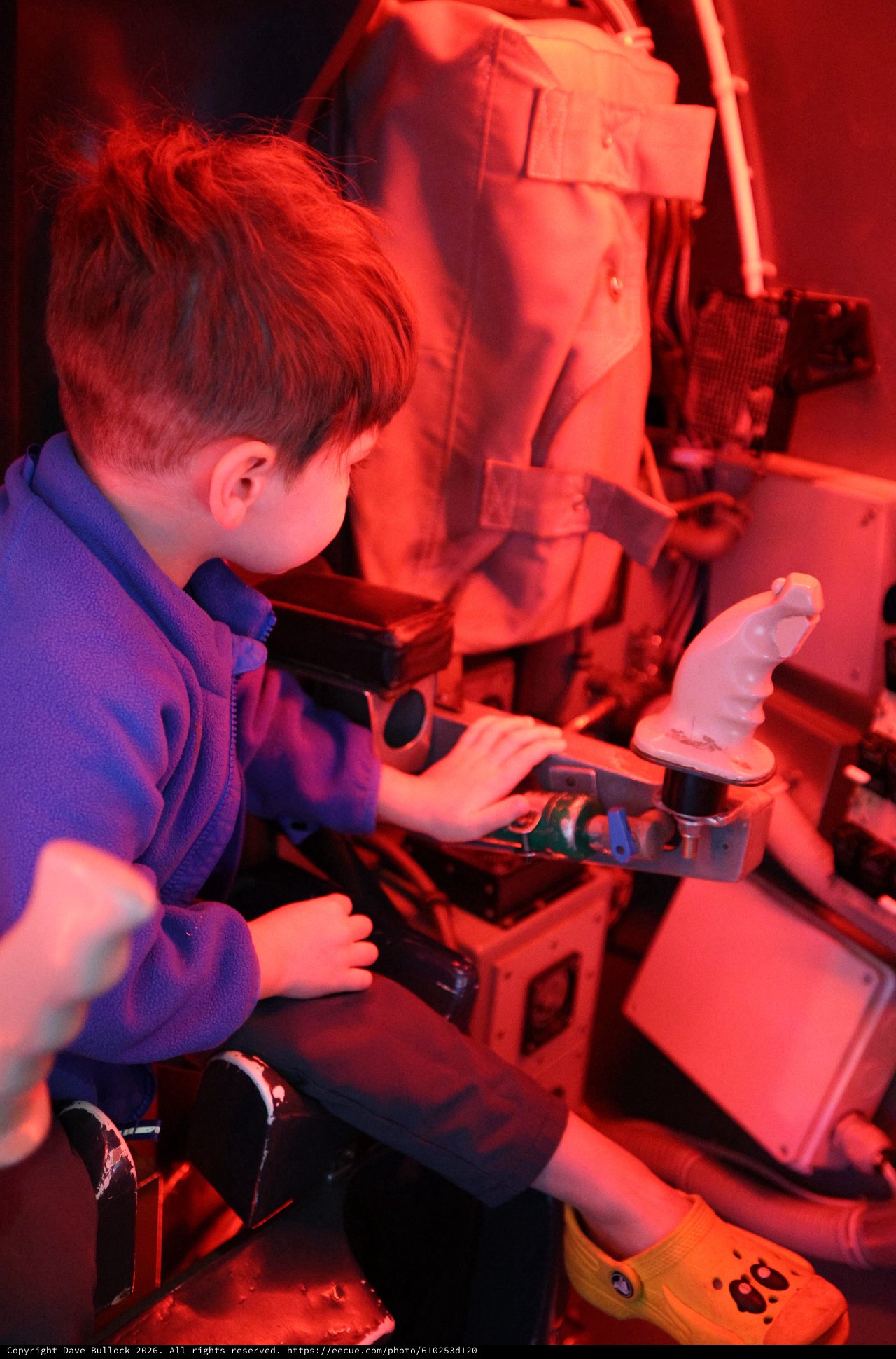 Young Student Exploring Science Under Red Light
