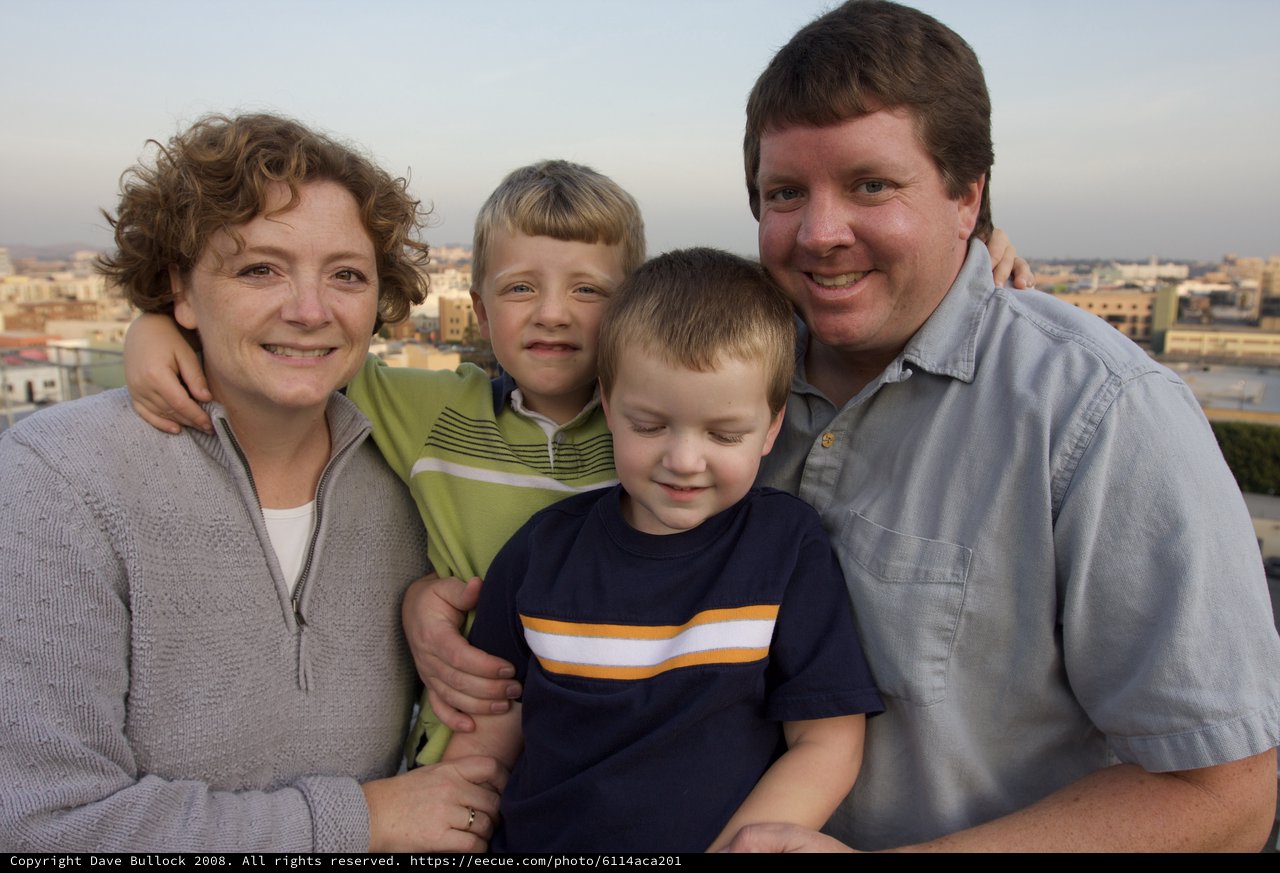 Family Portrait at Sunset Over City Skyline