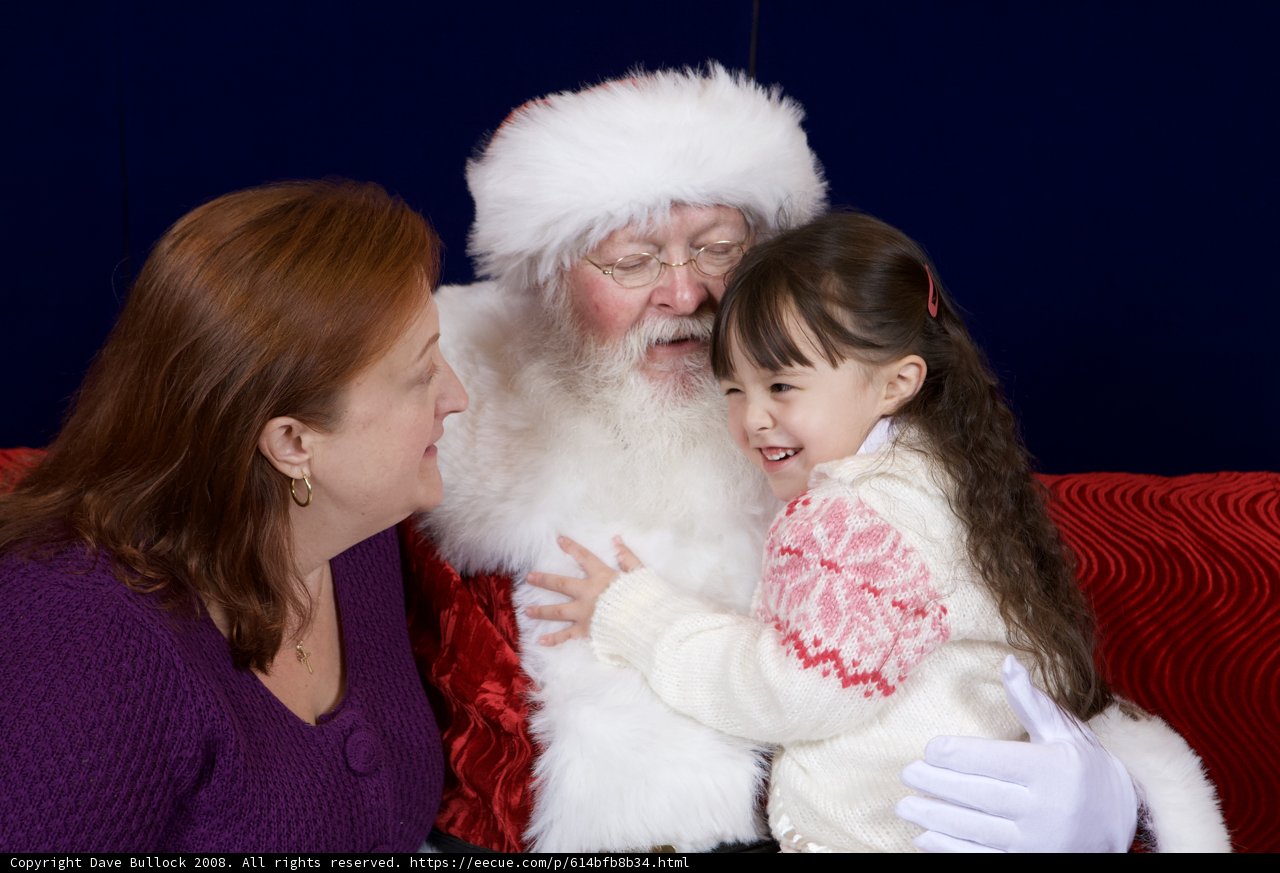 Santa Claus joins a mother-daughter duo on the couch