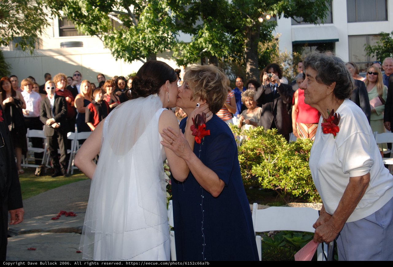 Bride Receives Tender Kiss at Outdoor Wedding Ceremony