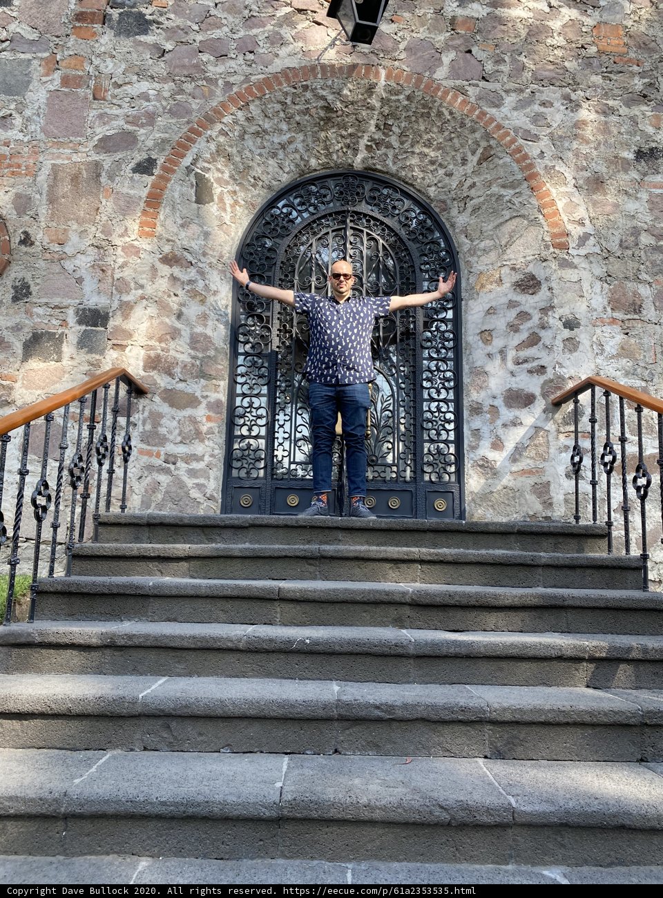 Man Standing on Stone Building Stairs