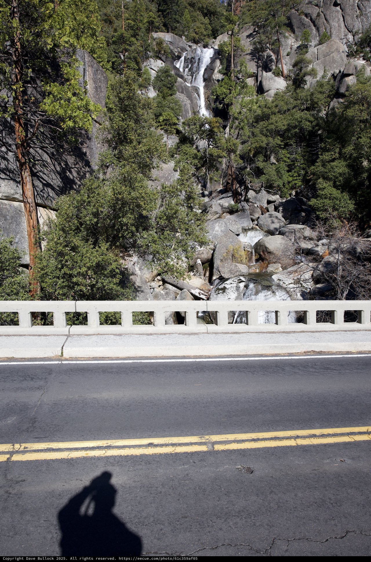 Mountain Highway with Cascading Waterfall Vista